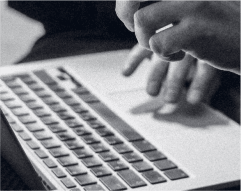 Close-up of a person using a laptop with productivity charts and financial graphs overlay